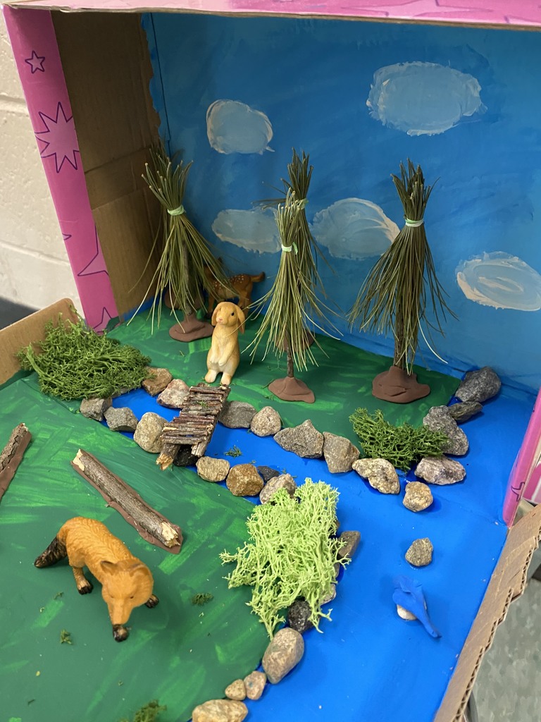 Animal habitat diorama of a river, trees, and rocks