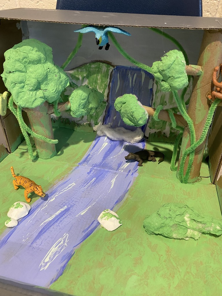 animal habitat diorama of river, trees, bird, and animal at the river