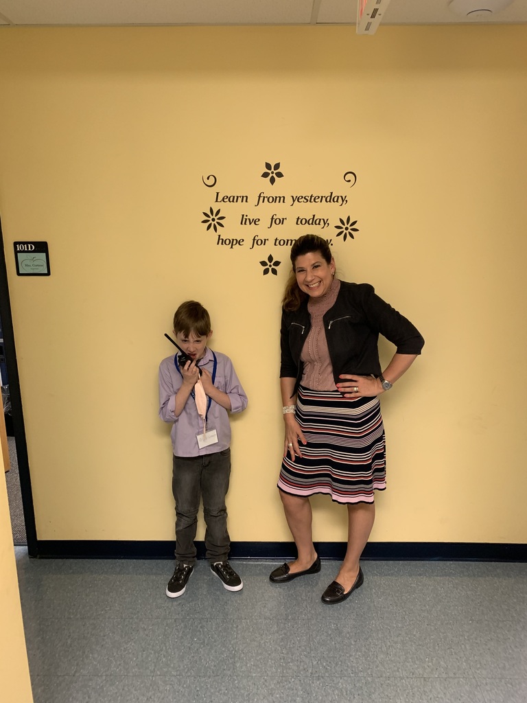 Student Principal for a Day standing with Principal Hebert holding her walkie talkie