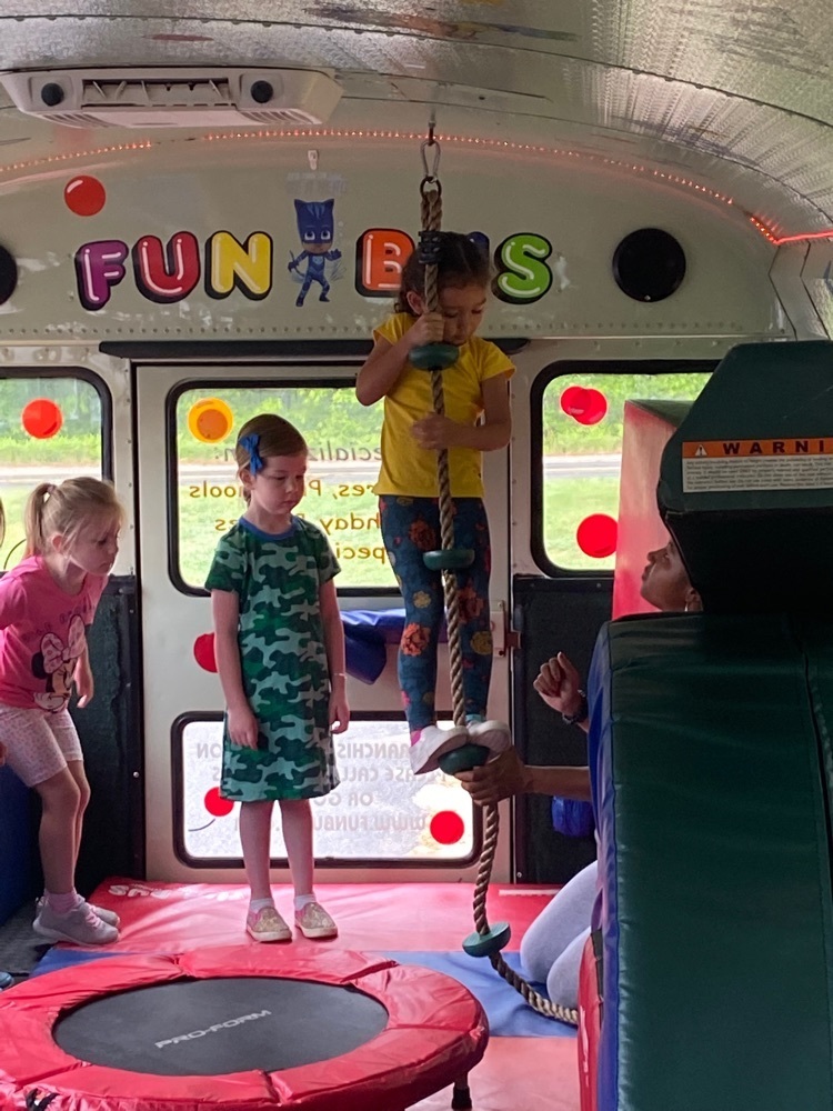 fun bus kids standing in front of trampoline climbing a rooe