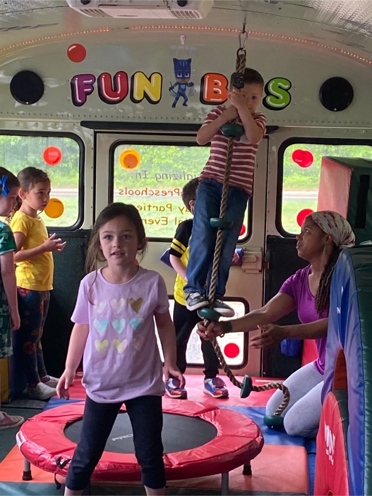 students playing on the fun bus climbing ropes