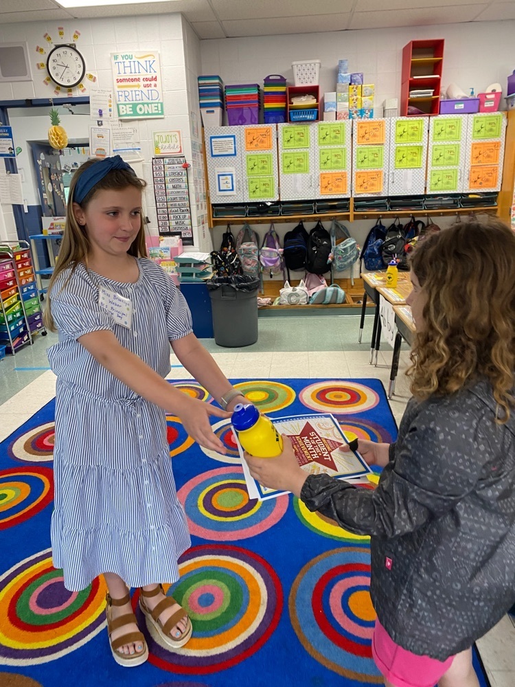 student handing out awards to students