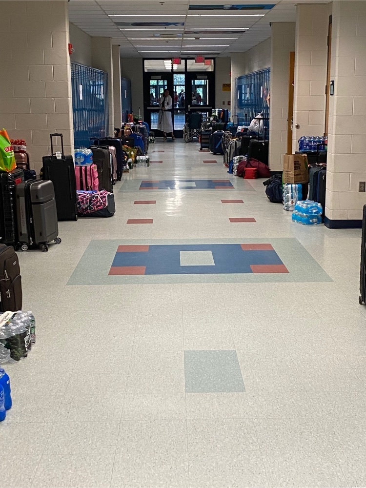 a hallway at school with luggage lining the hallways