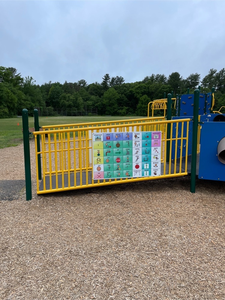 picture of a communication board hung on the playground railing