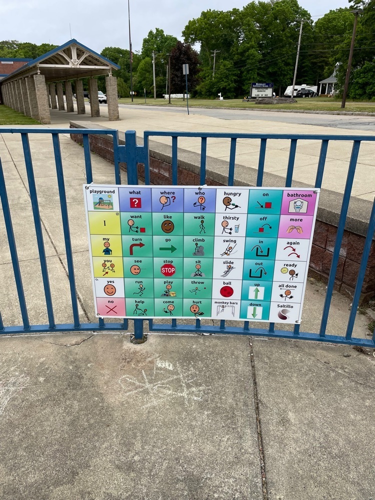 picture of a communication board hung on the playground railing