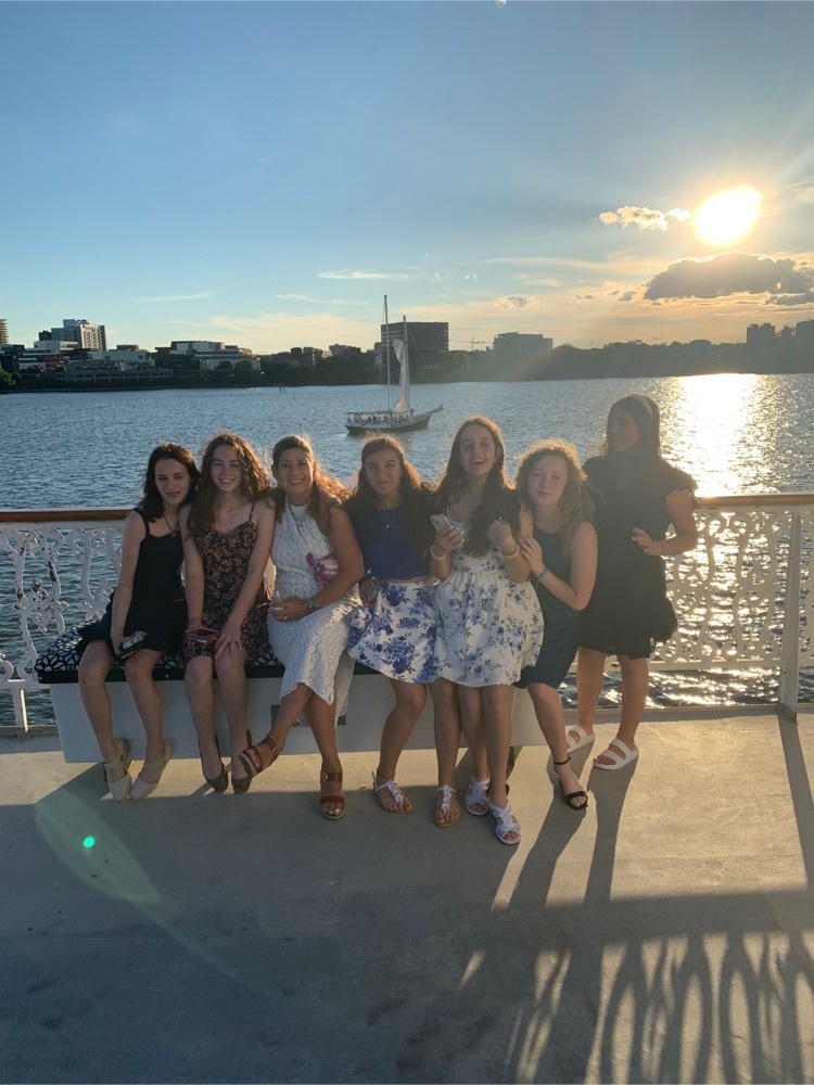 a group of girls posing in front of the bay 