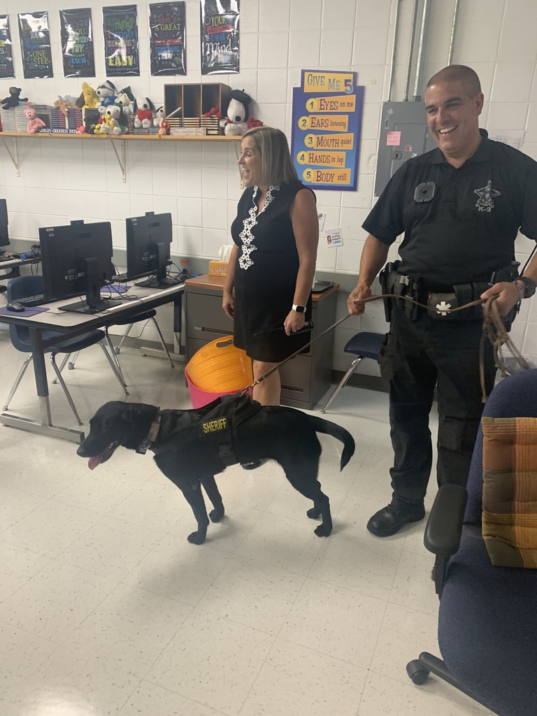 Comfort dog with the sheriff and Principal Francisco