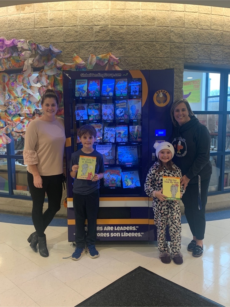 principals and students with the book vending machine 
