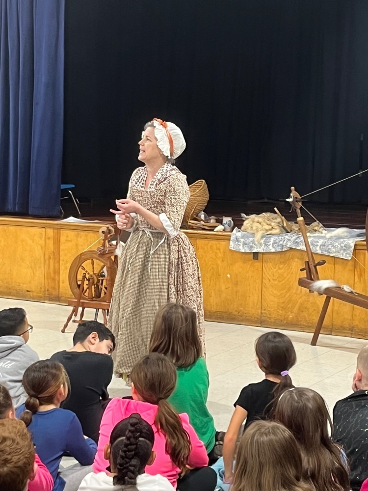 colonial woman presenting to students 